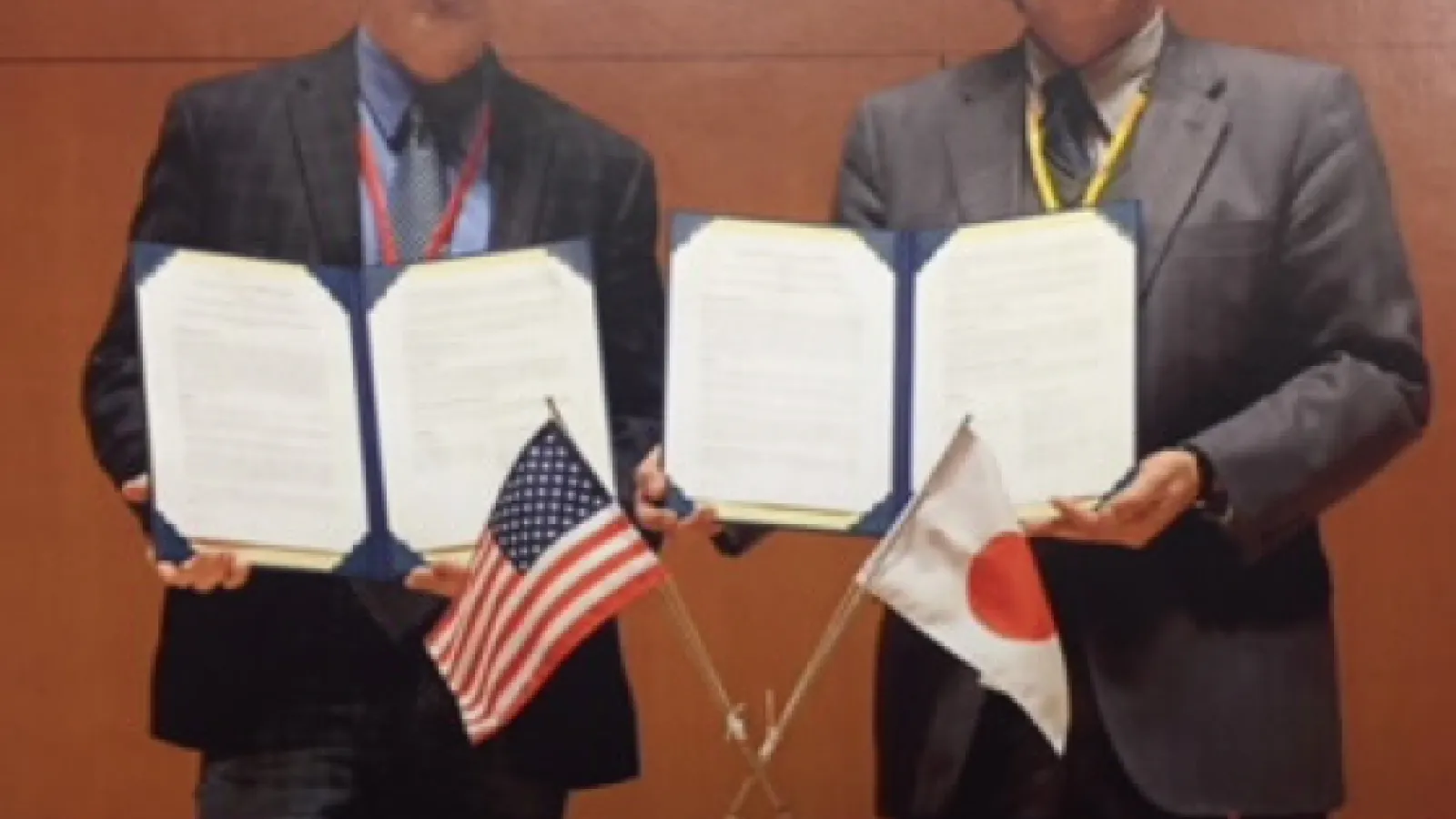 Representatives from OSU and Kyoto University hold up the Memorandum of Understanding